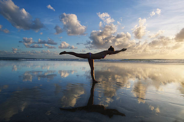istock yoga on the beach 521760109
