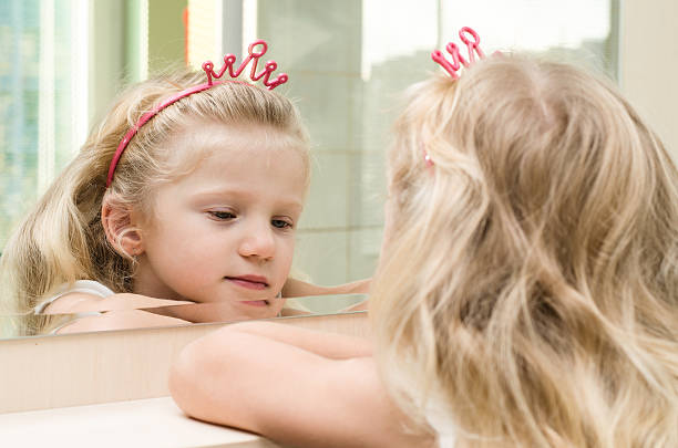 istock blond girl in mirror 521760873