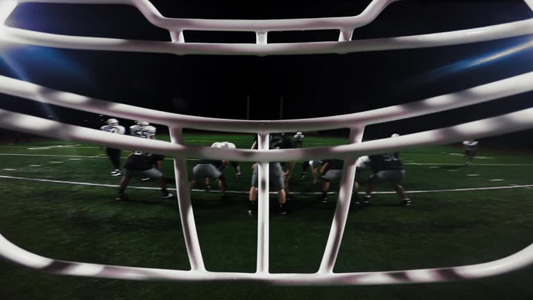 First person point of view from inside a football player's helmet, as the player makes a touchdown