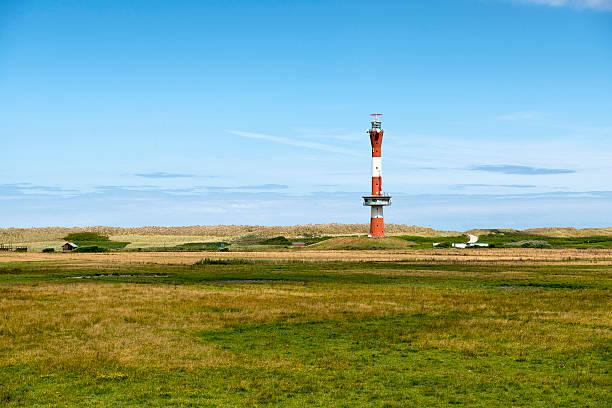 Red and white striped lighthouse on levee at night. Taken in Wilhelmshaven, Lower Saxony, Germany.