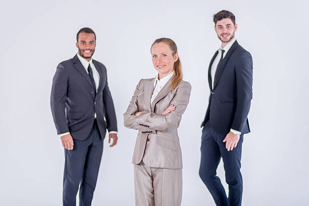 Portrait of a young businesswoman standing amongst her colleagues outdoors