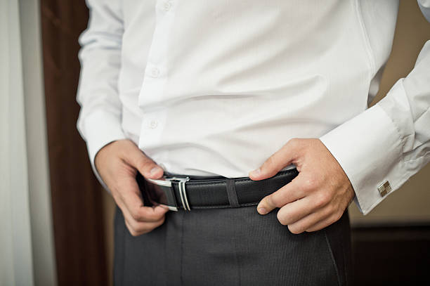 istock The man corrects a belt. 521787495
