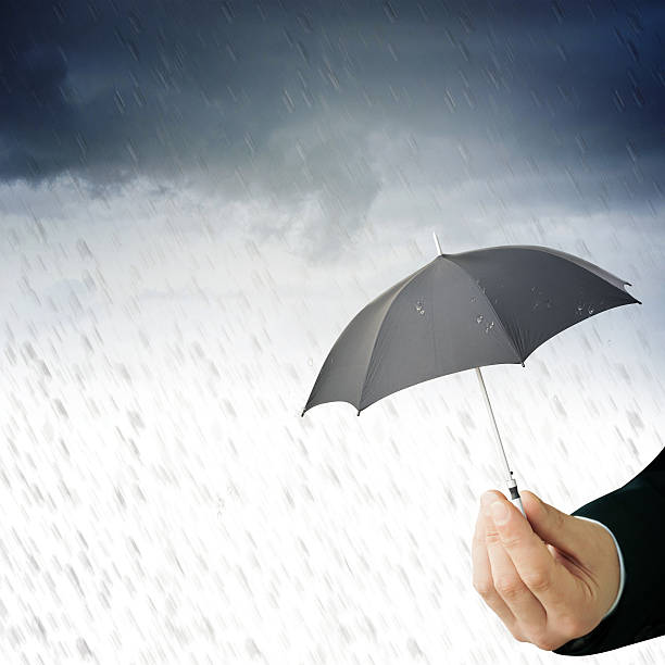 istock Human hand holding an umbrella 521788017