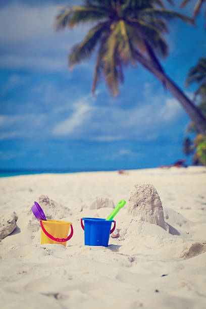 istock kids toys on sand beach 521789401