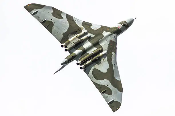 A vintage Vulcan bomber bearing no unique identifying markings is captured in flight. 