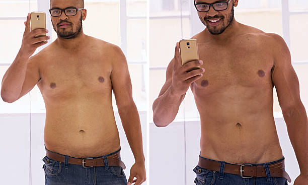 Dang! I look great! Shot of a handsome young man taking a selfie before and after his diet fat guy no shirt stock pictures, royalty-free photos & images