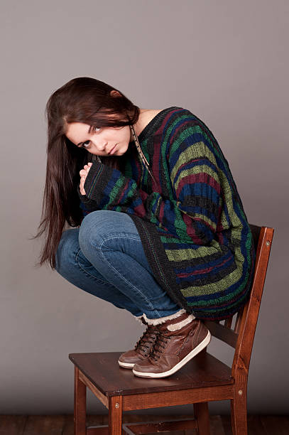 istock Stylish young girl posing over gray 521792201
