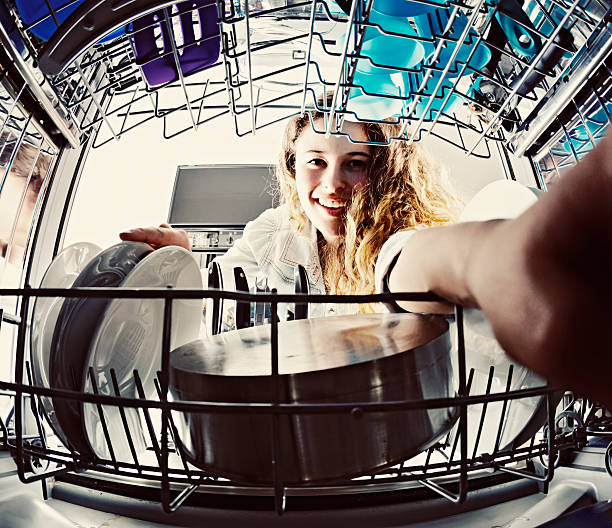 istock Smiling teenager helps with dishwashing  duties 521793349