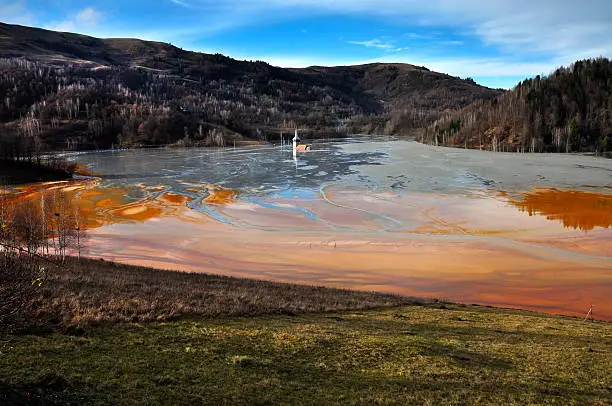 Red polluted lake in Geamana, Rosia Montana, Romania