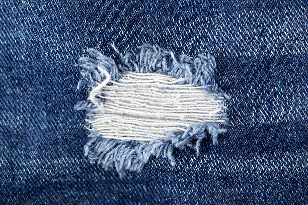 istock Torn blue denim jeans, detail texture 521794251