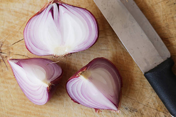 istock Fresh red onions on a wooden background 521794718