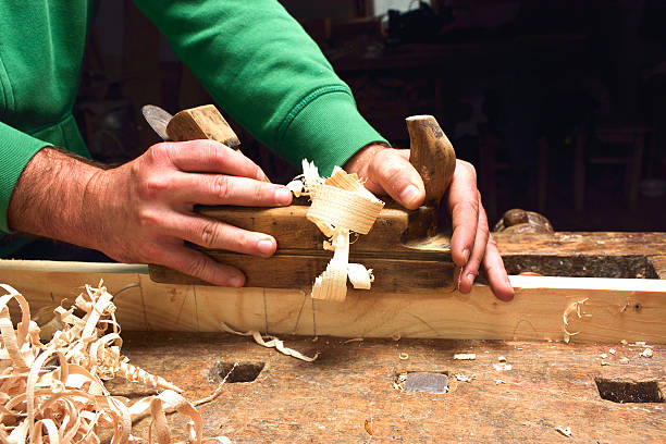 istock carpenter working with plane on wooden 521794910