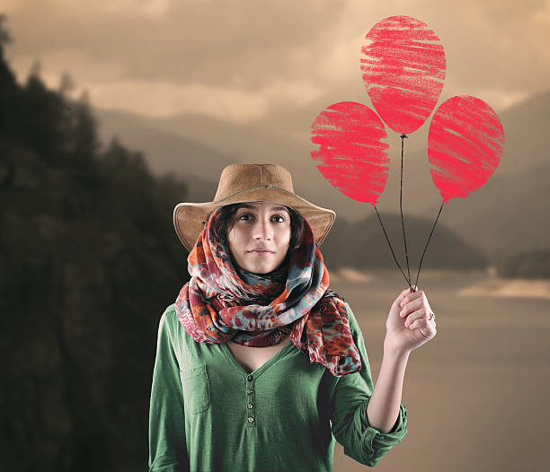 istock Young woman with red balloons. 521795080
