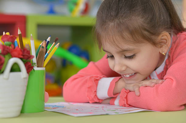 istock Little girl drawing at home 521797218