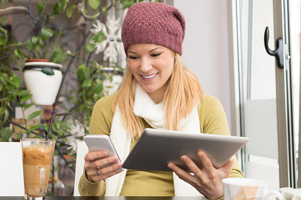 istock Attractive woman using digital tablet and smart phone at cafe 521798282