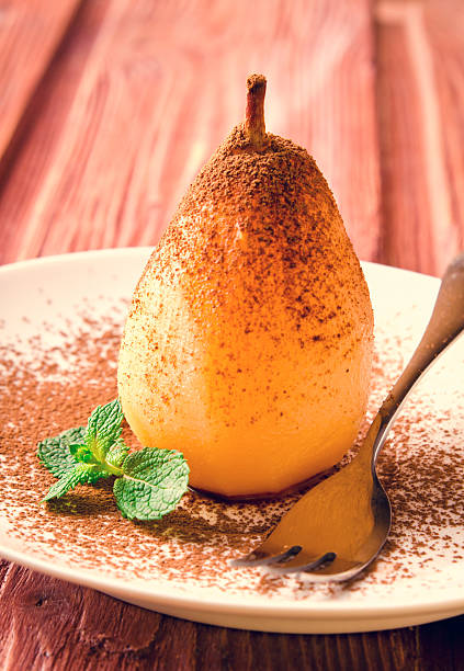 istock Poached pears with cocoa and mint on white plate 521798312