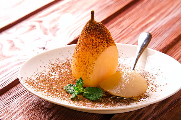 istock Poached pears with cocoa and mint on white plate 521798342