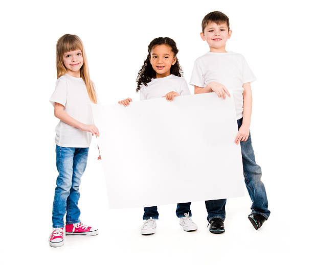 istock three children of different complexion with an empty paper sheet 521798726