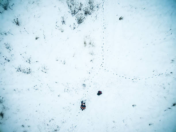 istock man manages quadrocopter on snowy field 521799016