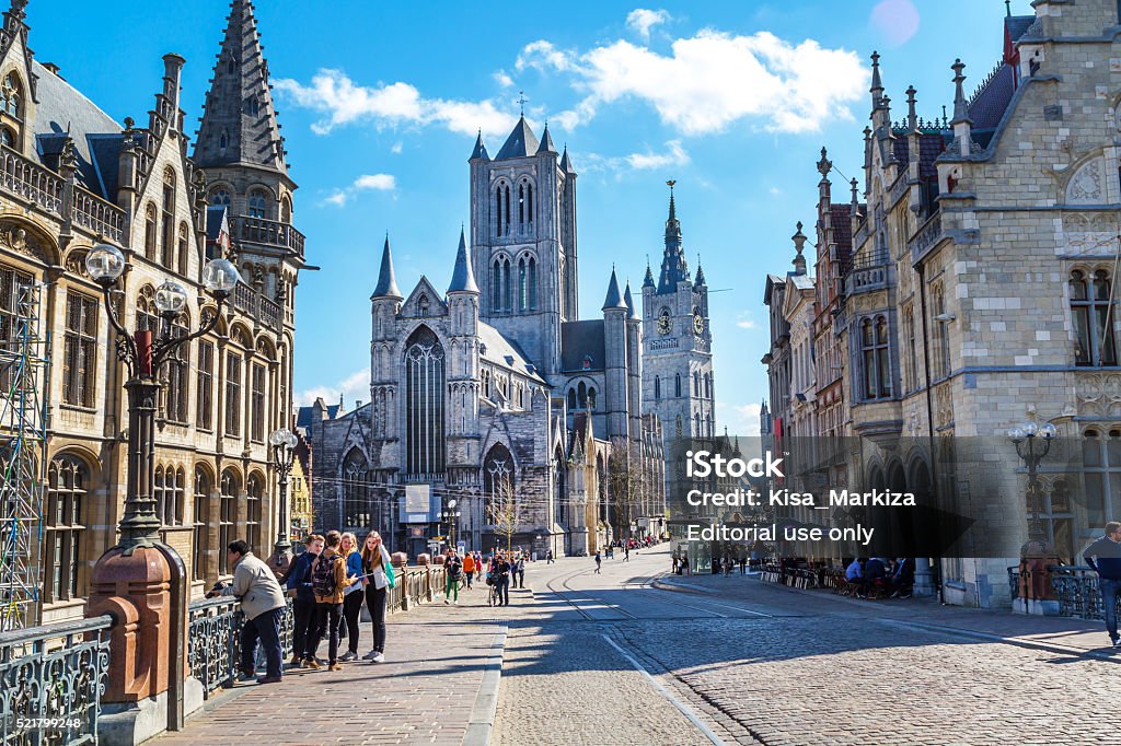 Street view of Ghent, Belgium with St Nicholas' Church Ghent, Belgium - April 12, 2016: Vibrant color street view of Ghent, Belgium with St Nicholas' Church, beautiful houses and people near it Ghent - Belgium Stock Photo