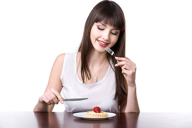 Young woman tempted to eat cake