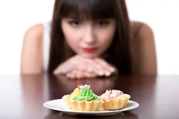 Photo of Dieting woman craving for cake