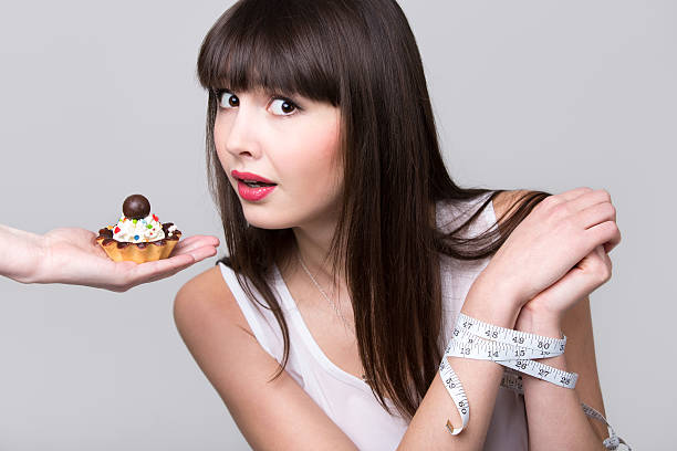 dieting woman got caught while trying to eat cake - control room stockfoto's en -beelden