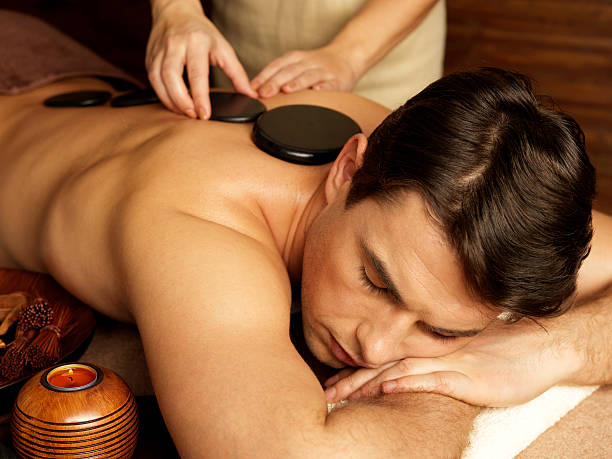 istock man having stone massage in spa salon 521800662