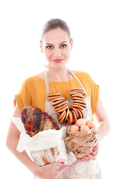 Pretty woman holding bowl with chicken eggs and baguette