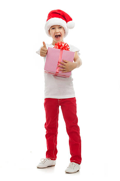 istock Child holding Christmas gift box in hand. Isolated on background 521802331