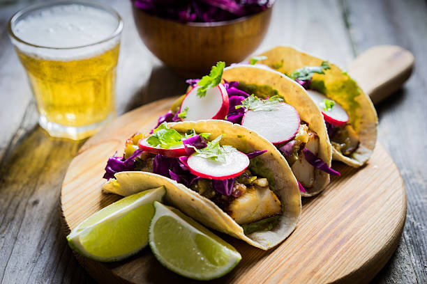 istock Fish tacoes on wooden background 521803085