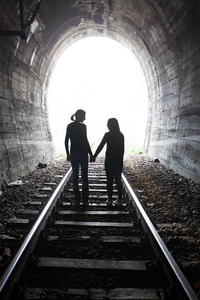istock Couple walking together through a railway tunnel 521804088