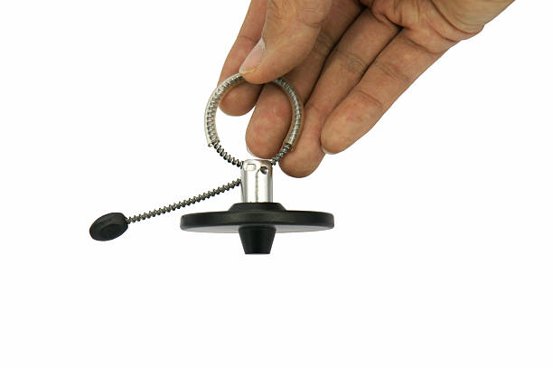istock Right male hand hold a magnetic bottle security tag isolated 521804276