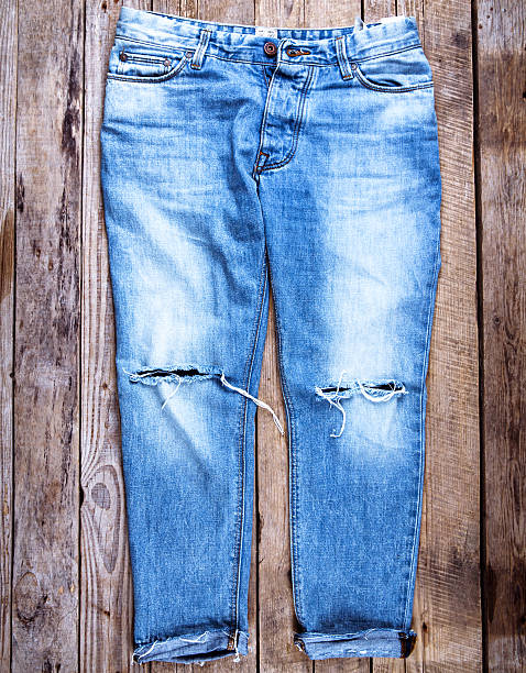 istock Jeans on wooden background 521804732