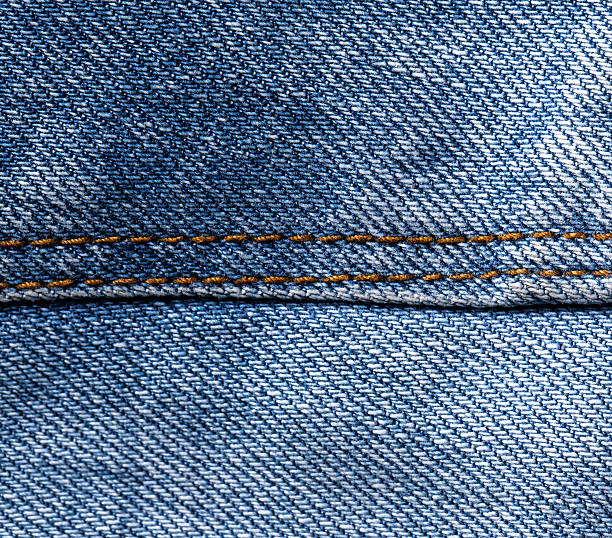 istock Stitched textured blue jeans  denim fabric background 521805780