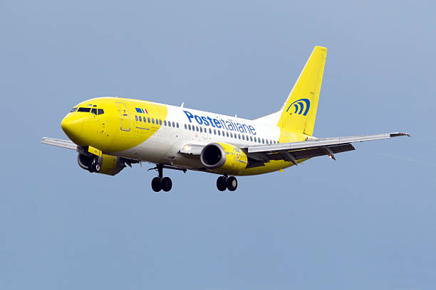 Italian Airlines 737 on finals Luqa, Malta - March 9, 2015: Poste Italiane (Mistral Air) Boeing 737-36E(QC) on finals for runway 31. mistral wind stock pictures, royalty-free photos & images