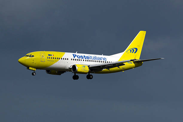 Italian Airlines 737 on finals Luqa, Malta - March 9, 2015: Poste Italiane (Mistral Air) Boeing 737-36E(QC) on finals for runway 31. mistral wind stock pictures, royalty-free photos & images