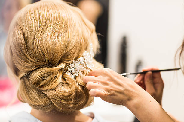 istock Hair stylist makes the bride before a wedding 521809134