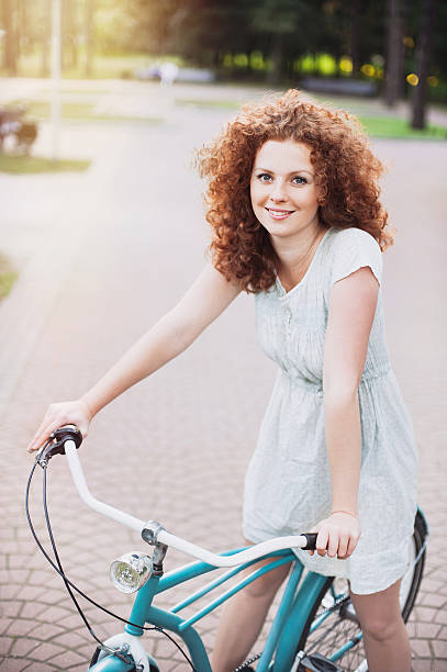 istock Beautiful woman with bike 521810258