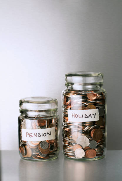 istock Pension and holiday change savings jars on counter 521810797