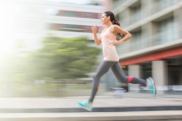 istock Woman running through city streets 521810877