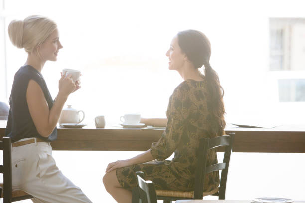 istock Women having coffee together at cafe 521810967