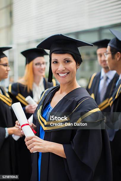 Student In Cap And Gown Standing With Friends Stock Photo - Download Image Now - 20-24 Years, 25-29 Years, 30-34 Years