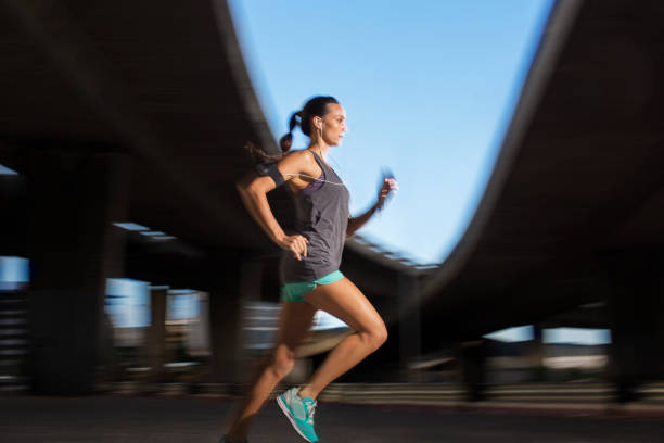 istock Woman running through city streets 521811131