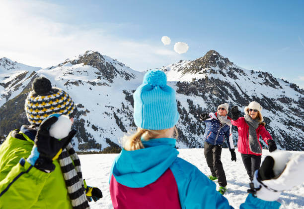 istock Family having a snowball fight on mountain 521811635