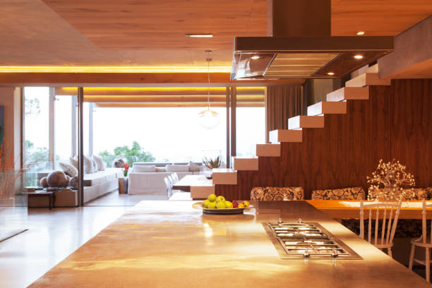 istock Countertop, staircase, and sofa in open modern kitchen and living area 521811643