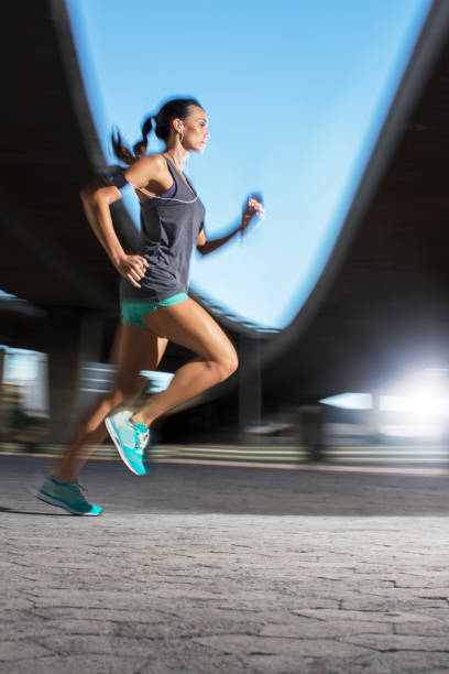 istock Woman running through city streets 521811945