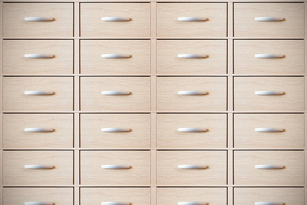 Horizontal composition color photography front view of a large group of modern furniture, multiple wooden drawer with a metal handle in center. Soft light technic for a 3D effect.