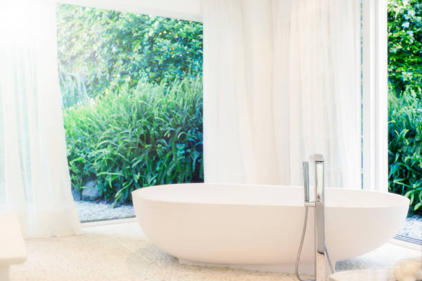 istock Bathtub, curtains, and windows in modern bathroom 521812137