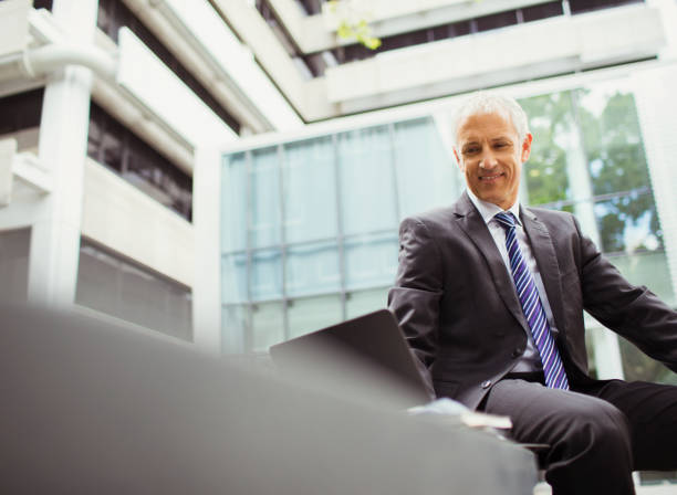 istock Businessman using laptop in office building 521812141